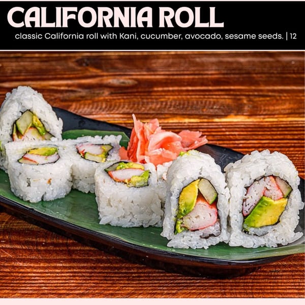 California roll sushi with kani, cucumber, avocado, and sesame seeds on a green plate with ginger.