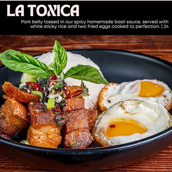 Pork belly with basil sauce, white sticky rice, and two fried eggs in a black bowl.