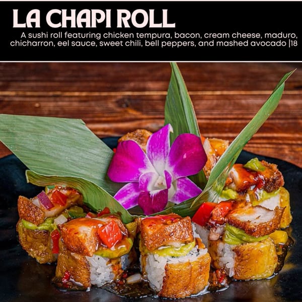 La Chapi Roll sushi with chicken tempura, bacon, avocado, and bell peppers, garnished with an orchid.
