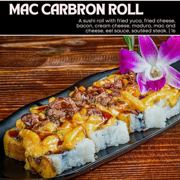 Mac Carbron Roll sushi with fried yuca, cheese, bacon, mac and cheese, steak, and a purple orchid.