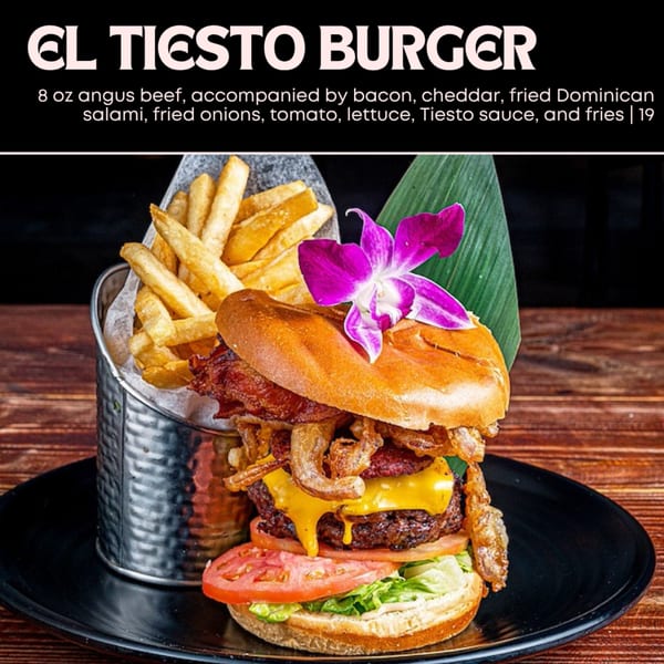 El Tiesto Burger with angus beef, bacon, cheddar, fried salami, onions, tomato, lettuce, and fries.