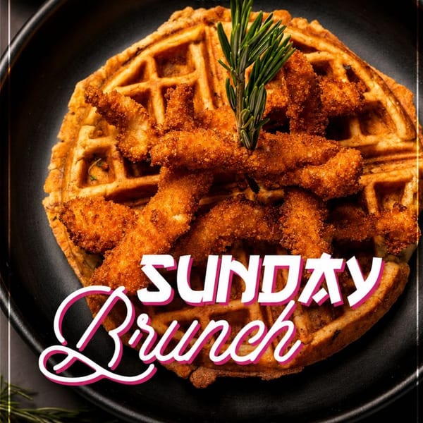 Crispy fried chicken tenders piled over a golden waffle on a black plate, garnished with rosemary and labeled Sunday Brunch.