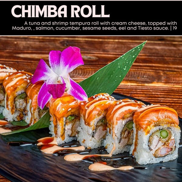 Chimba Roll, a tuna and shrimp tempura roll with cream cheese, topped with salmon and Tiesto sauce.