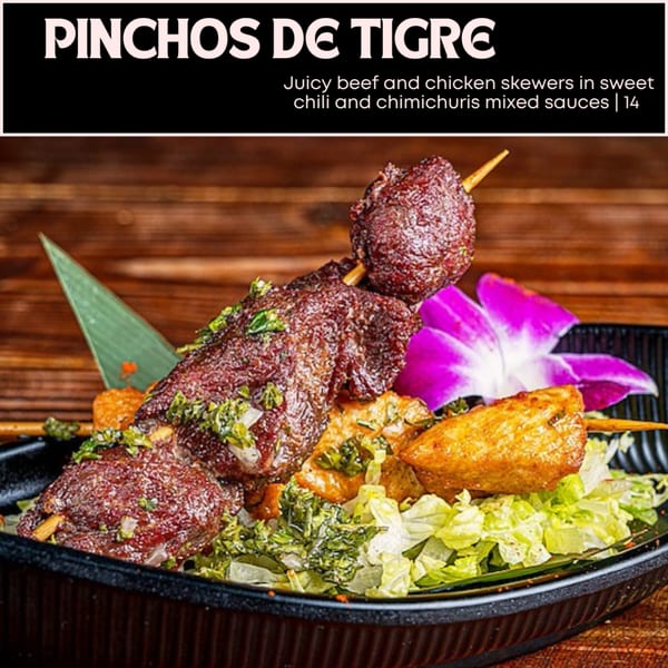 Pinchos de Tigre: beef and chicken skewers with sweet chili and chimichurri sauces, served on lettuce.