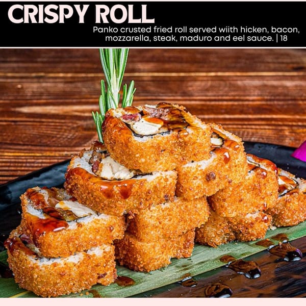 Crispy fried sushi rolls with eel sauce and rosemary garnish on a dark plate.